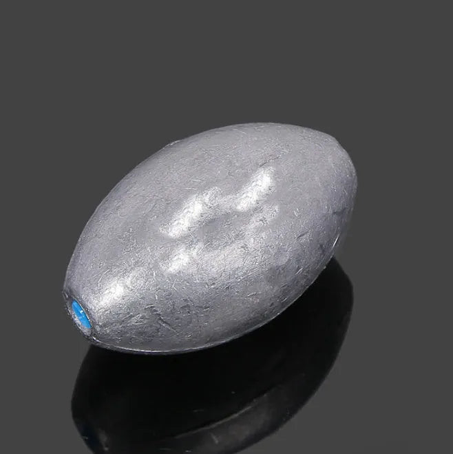 Tongxin olive lead fishing sinker with scale pattern and plastic core in rugby shape.