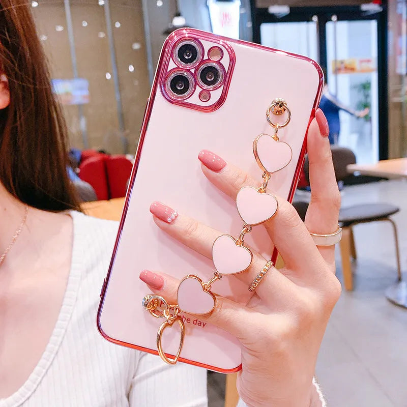 Samsung mobile phone in a solid colour silicone case with an adjustable bracelet strap attached.