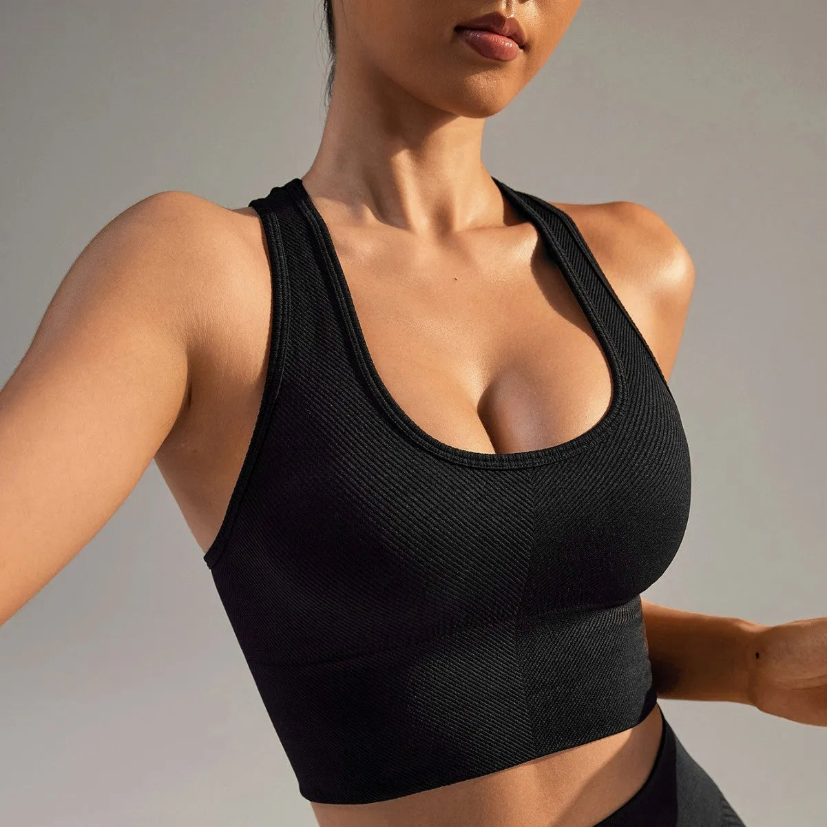 Black women's cross-back sports bra with moulded cups on a mannequin.