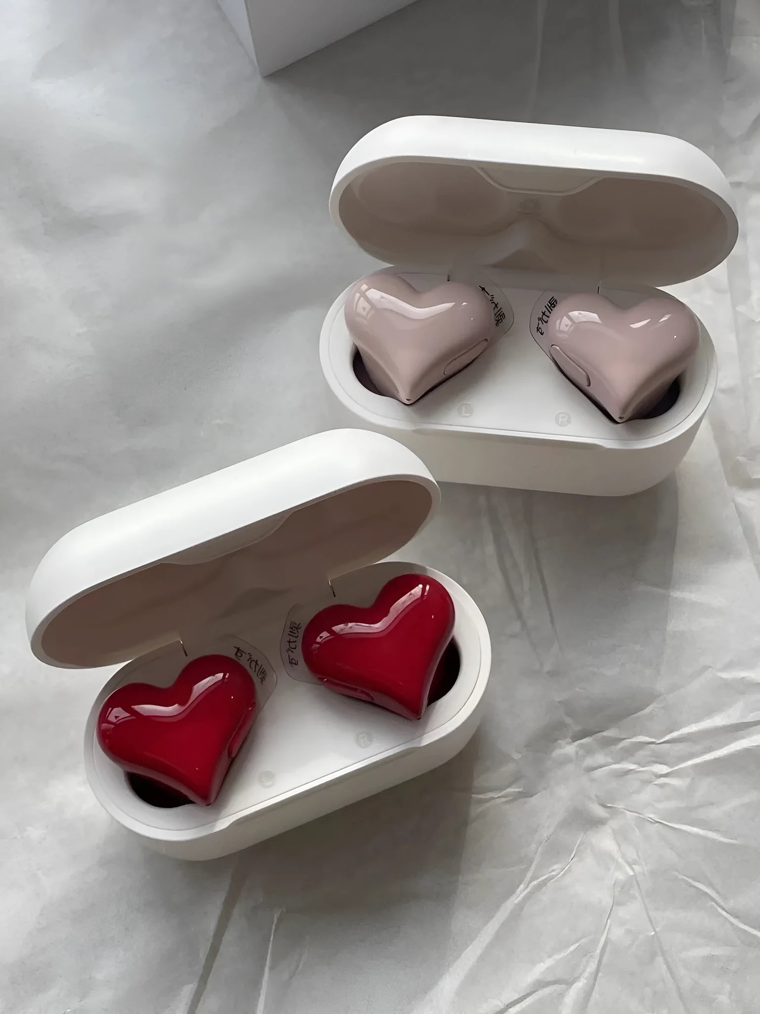 Heart-shaped wireless Bluetooth headphones in Chinese red or girl pink colours with in-ear design