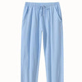 Men's loose-fitting cotton linen casual trousers in khaki colour on a neutral background.