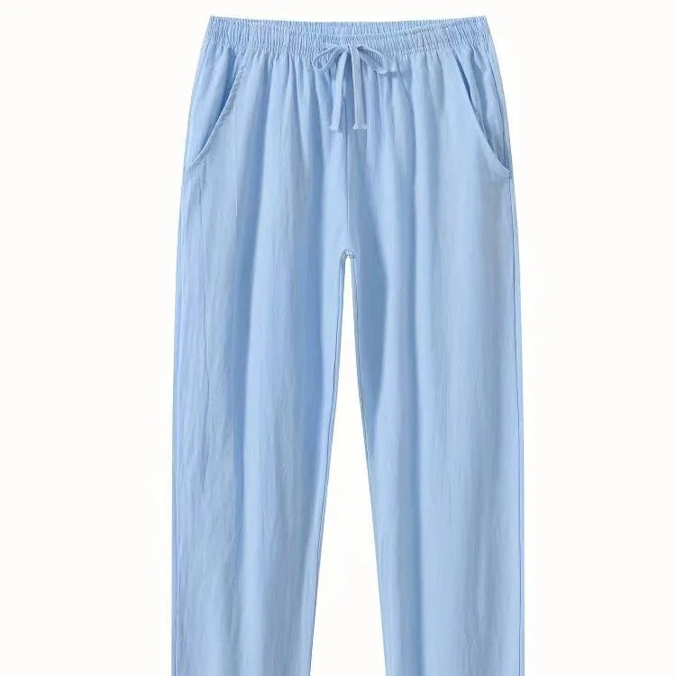 Men's loose-fitting cotton linen casual trousers in khaki colour on a neutral background.