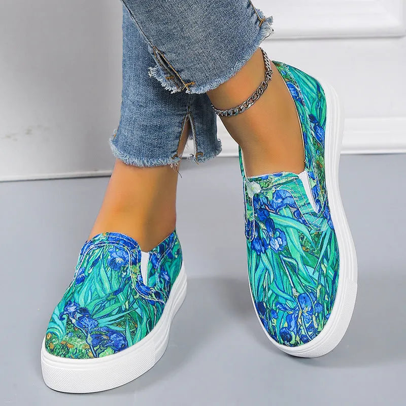 Women's low-top canvas trainers in blue, green, black and colourful patterns with a flat rubber sole.