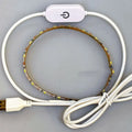 Photon Lighting flexible USB LED light strip bent into a curve showing its adhesive backing and touch control.
