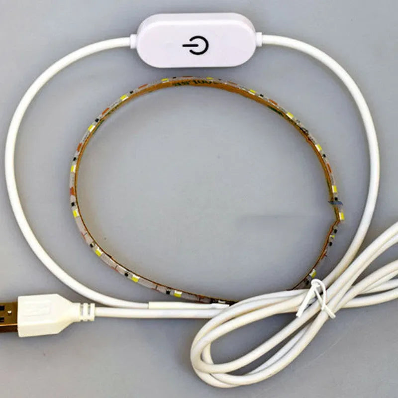 Photon Lighting flexible USB LED light strip bent into a curve showing its adhesive backing and touch control.