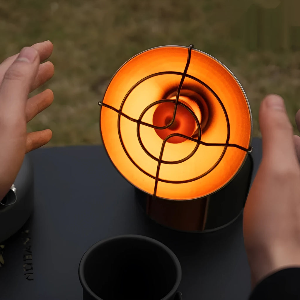 Portable outdoor heating stove with black and orange design showing automatic press ignition