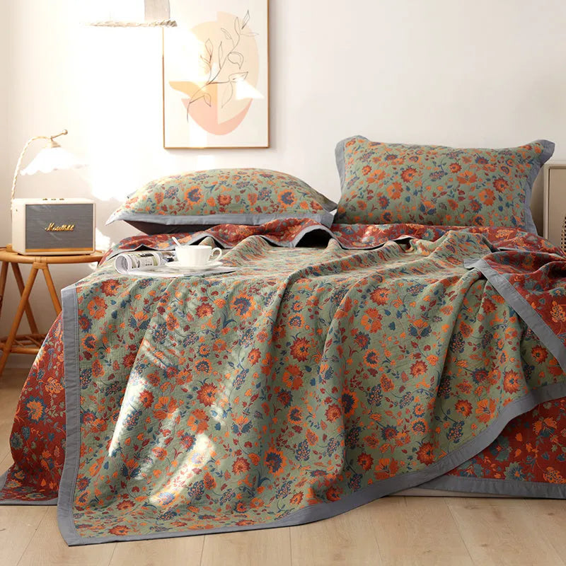 Three-piece cotton gauze bed blanket set with botanical floral pattern showing blanket and two pillowcases