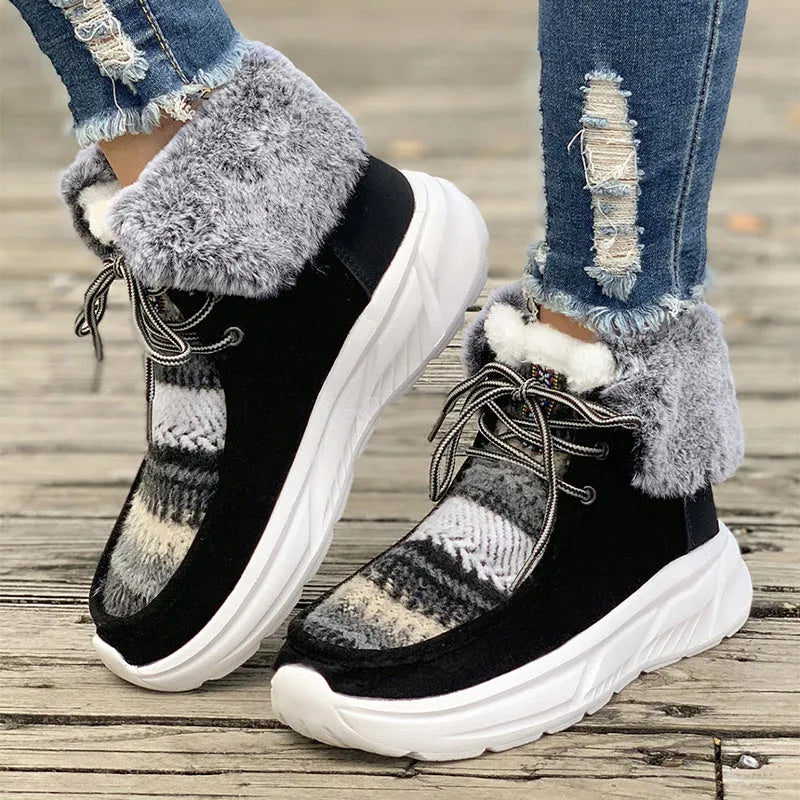 Women's beige lace-up snow boots with a suede upper and thick platform sole.