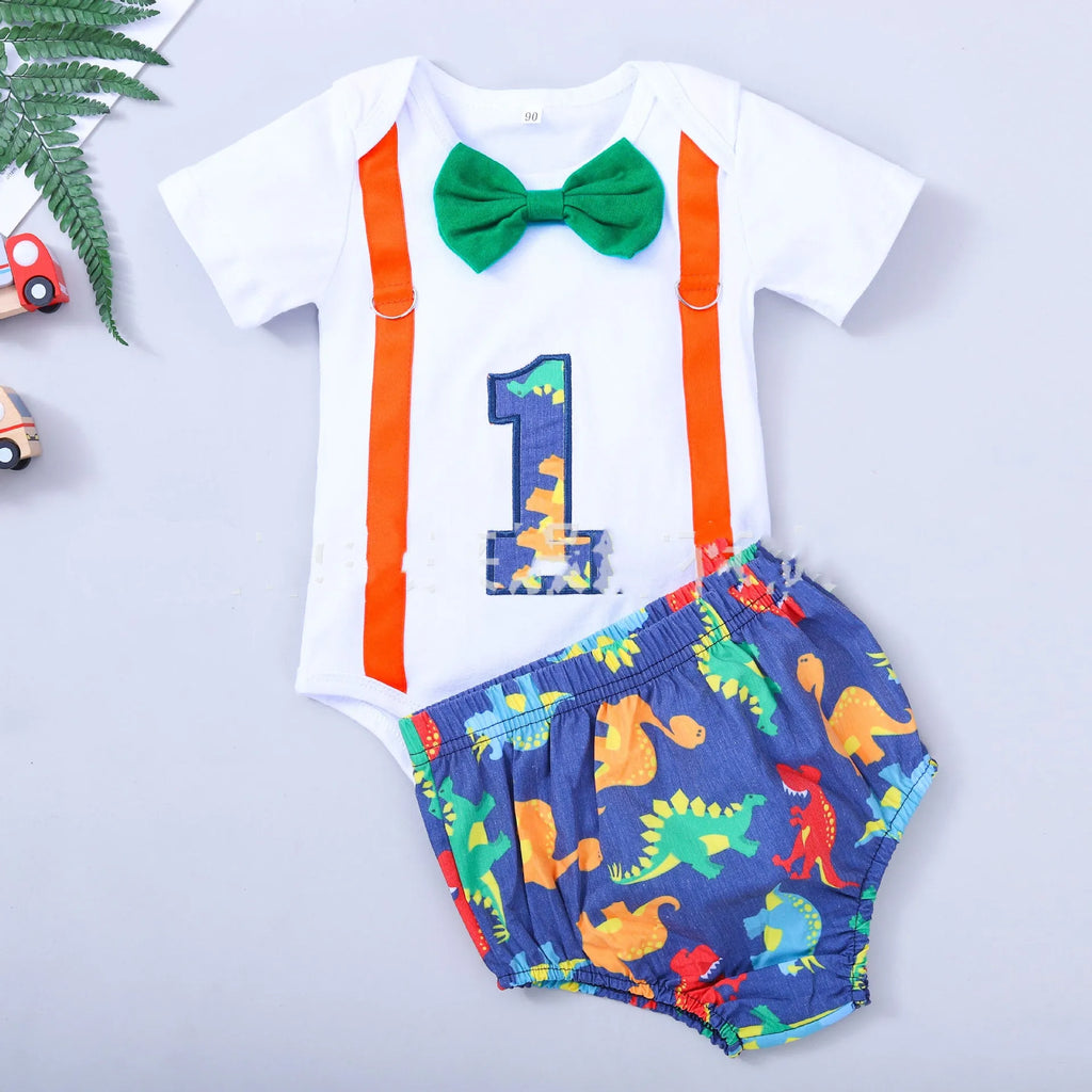 Baby wearing a blue cotton romper shorts with dinosaur print and straps.