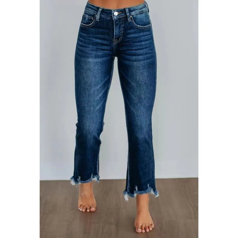 Women's dark blue cotton denim jeans with hand-worn distressing detail on the front.