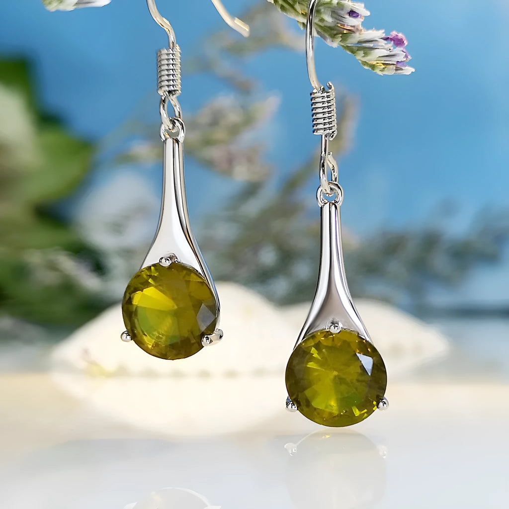 A pair of simple olive green drop-shaped earrings with a retro style on a white background.