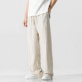 Men's beige cropped linen trousers with a drawstring waist and straight-leg casual style on a hanger.