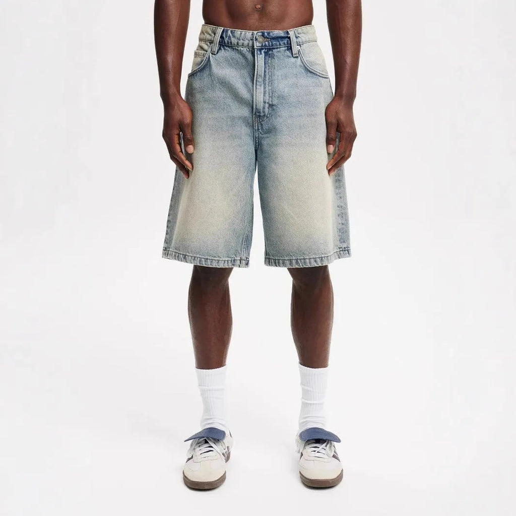 Men's loose fit light blue straight leg cotton jeans on a hanger.
