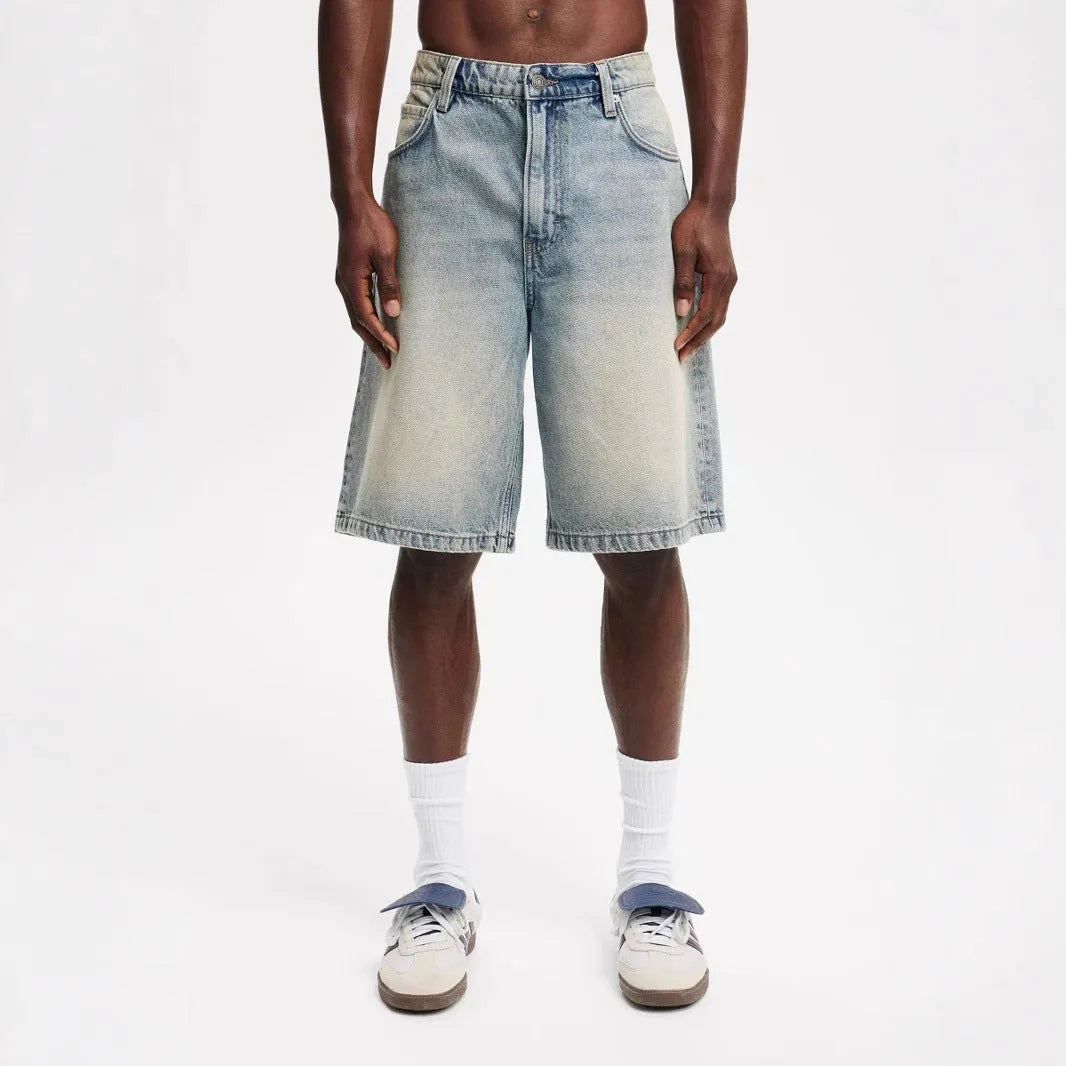 Men's loose fit light blue straight leg cotton jeans on a hanger.