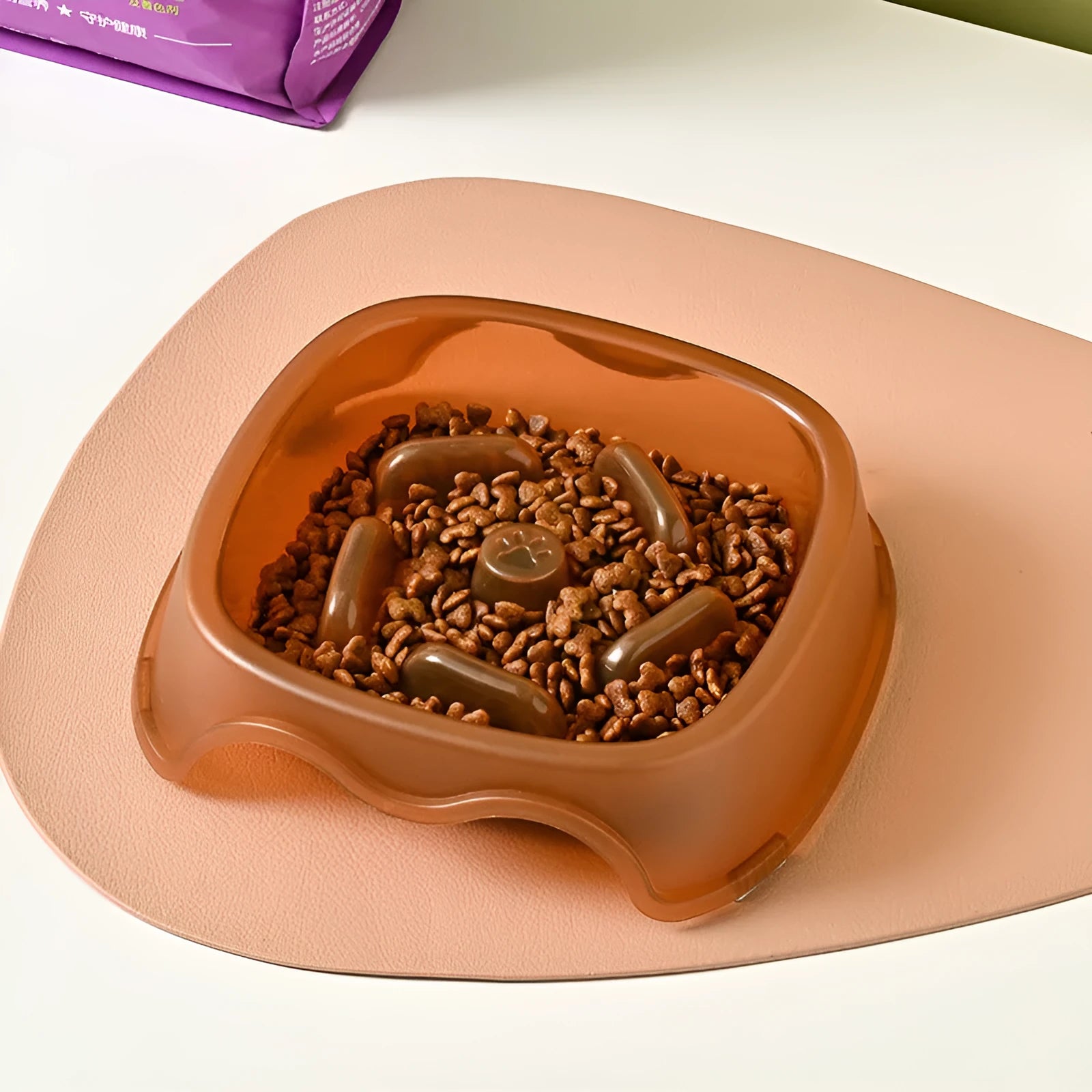 Blue plastic slow feeder dog bowl with raised internal maze pattern to prevent fast eating.