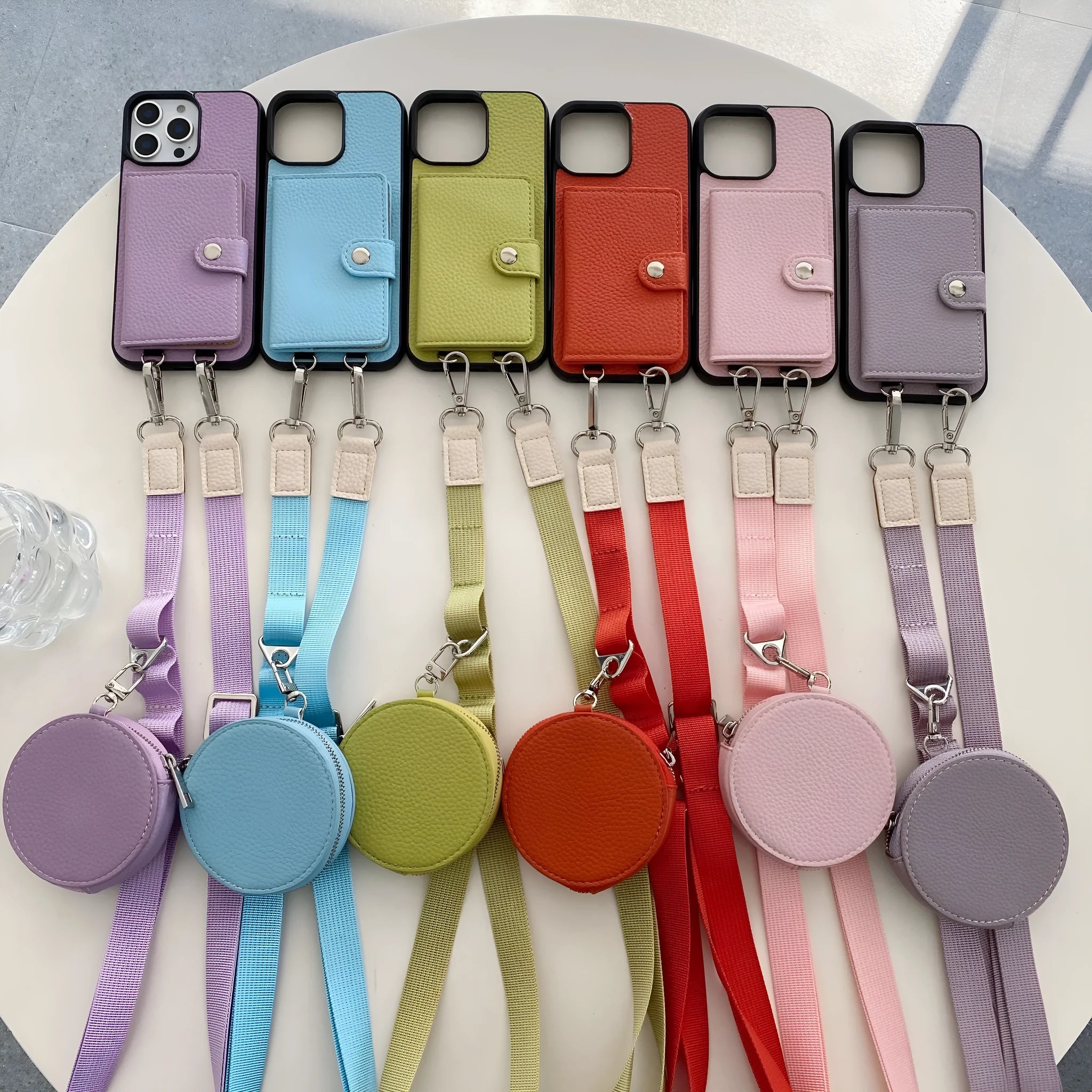 Black PC leather card holder phone case for iPhone with wrist lanyard attached.