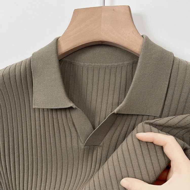 Man wearing a black and white striped mulberry silk T-shirt with a lapel collar.