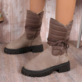 Women's chunky heel snow boots in suede with lace-up design and fleece lining, shown in black.