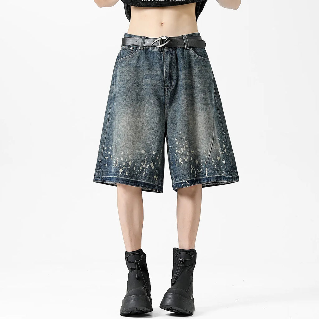 Men's retro blue denim shorts with ripped details, splash ink design, and five-point star decorations on a straight-leg cut.