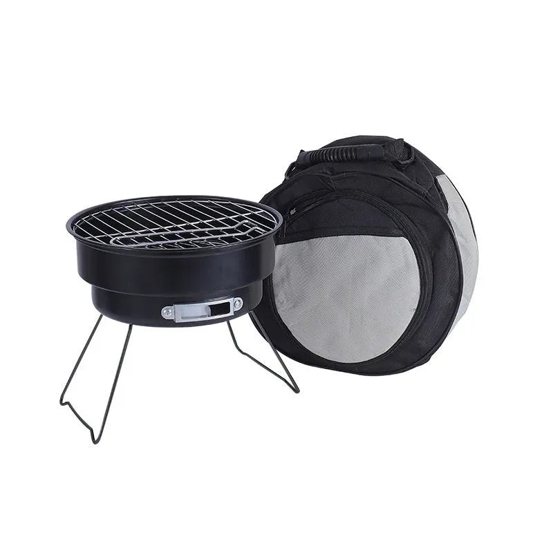 Small metal round folding ice stove with grill mesh and legs set up for barbecue.