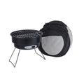 Small metal round folding ice stove with grill mesh and legs set up for barbecue.