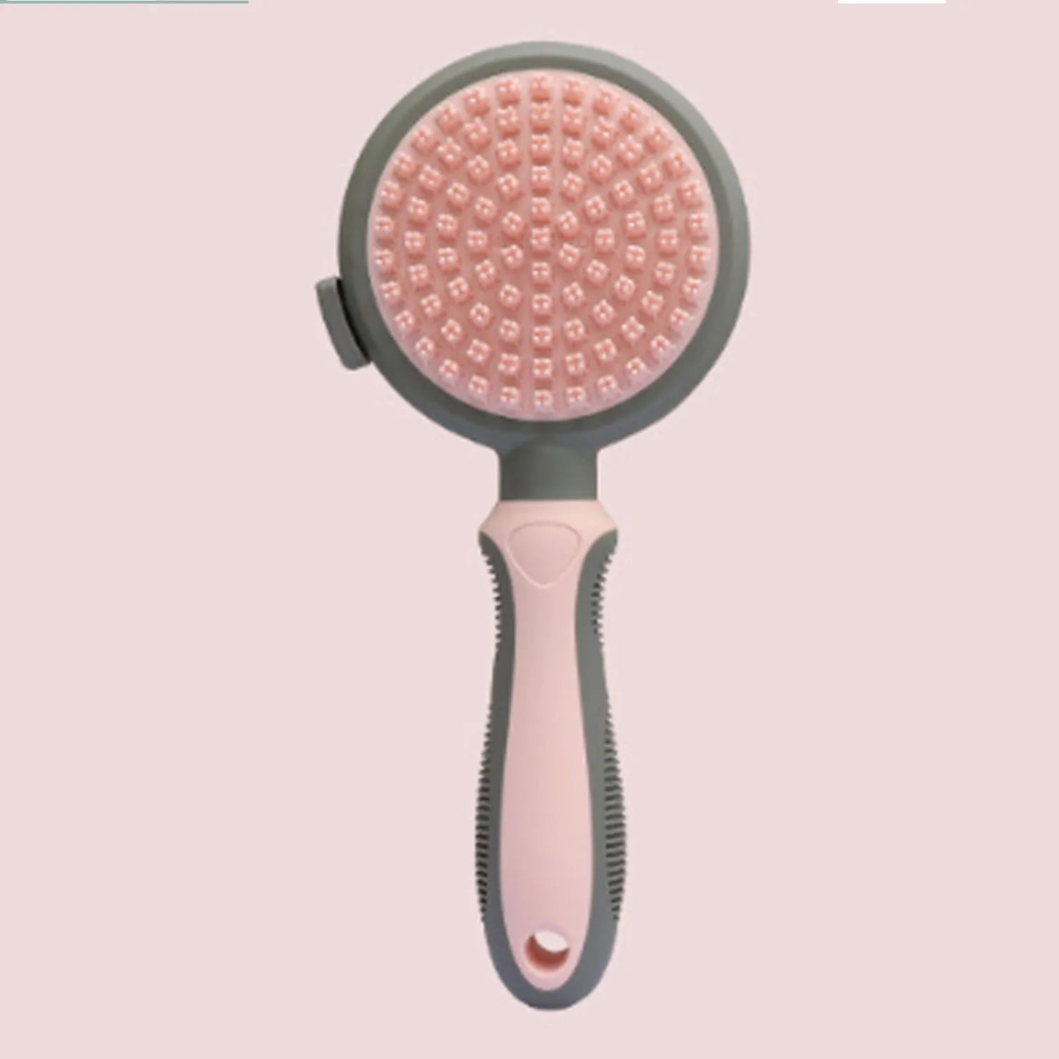 Double-sided pink cat brush with slicker bristles on one side and flea comb on the other, showing hair release button
