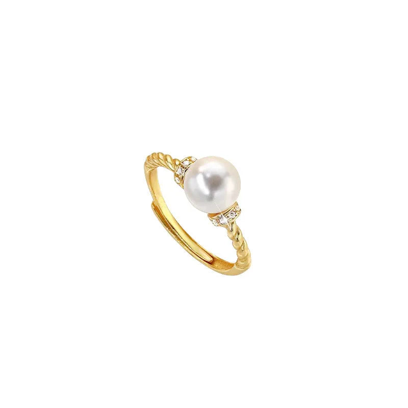 Adjustable antique twist copper ring with a central pearl inlay, shown in gold and silver tone finishes.