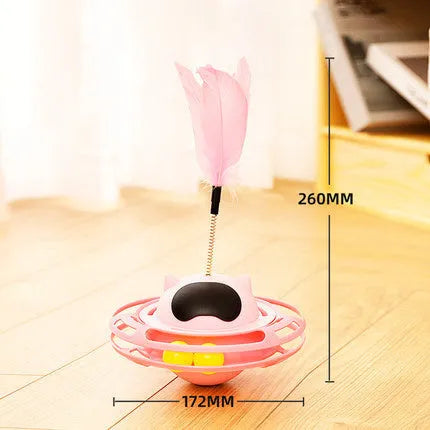 Pink cat tumbler turntable toy with interactive play stick on a flat surface.