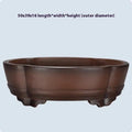 A rectangular purple clay bonsai pot with a simple classical design, shown on a tabletop.