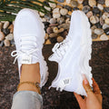 Women's low-top mesh casual shoes in beige with a Flyknit-style upper and platform sole.