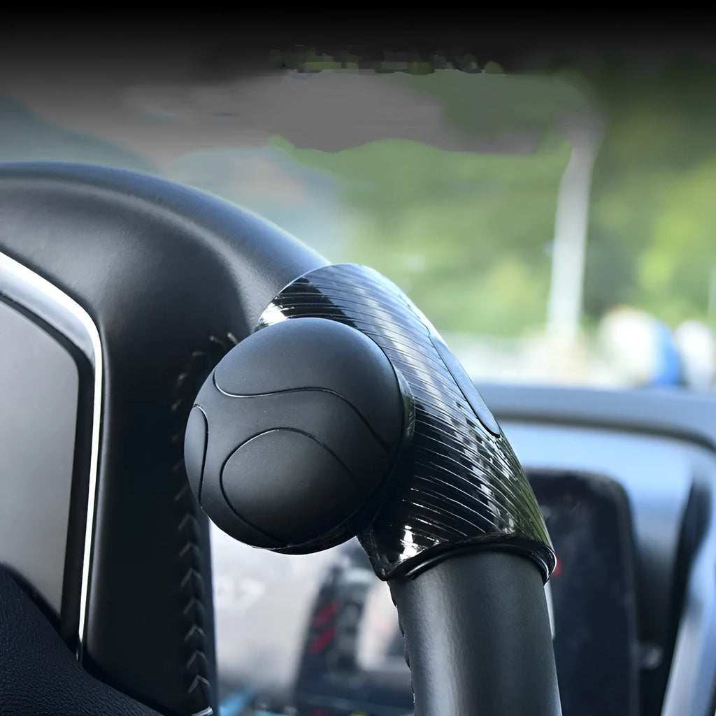 Black and blue steering wheel assist balls with silicone grip, showing approximate 9cm by 6cm size.