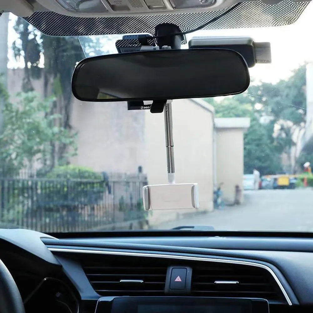 Black ABS car phone holder mounted on a rearview mirror showing 360-degree rotation mechanism