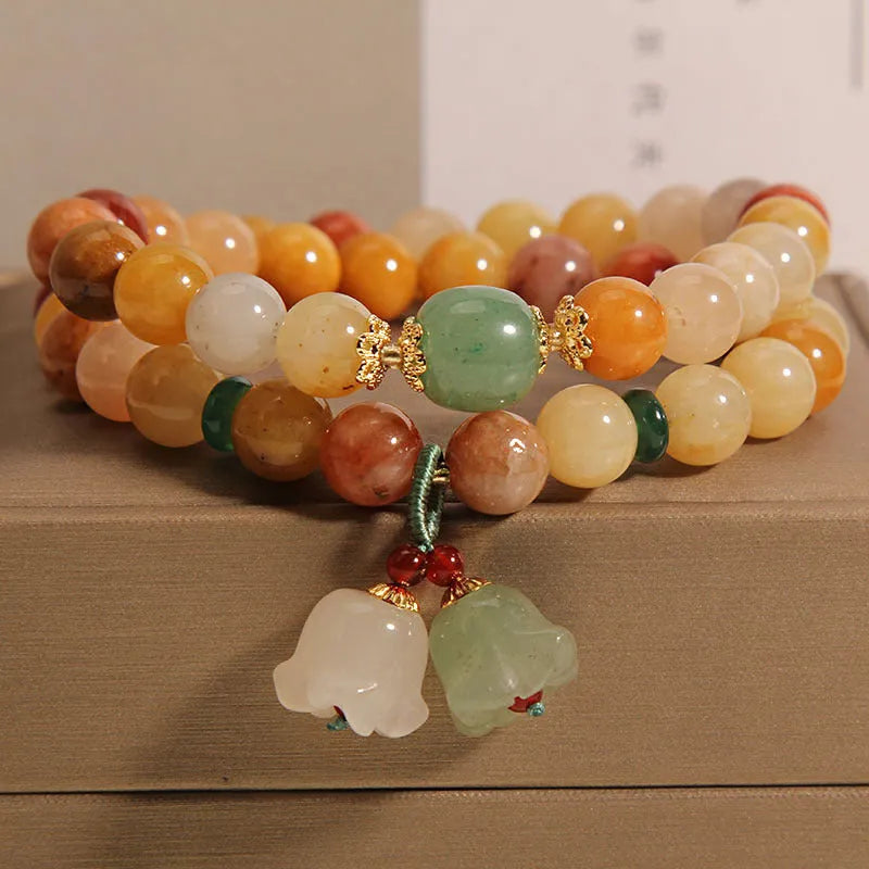 Natural jade multi-layer bracelet for women with an orchid pendant on an adjustable fastening.
