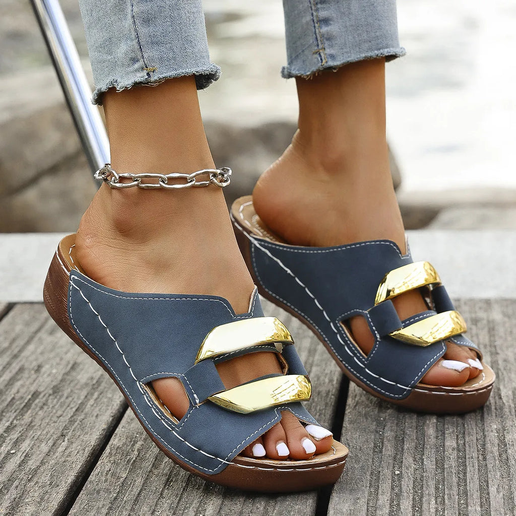 Roman style platform sandals in black with metal details and a rubber sole.