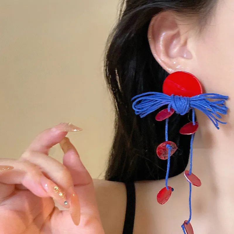 Handcrafted geometric cloth earrings with blue resin flower and silver needle detailing