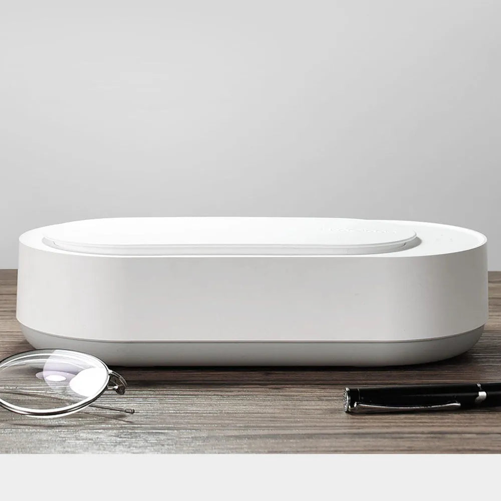 White portable ultrasonic cleaner with stainless steel tank and touch button.