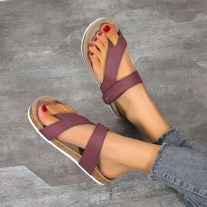 Blue thick-soled flip-flops with a flat toe ring on a light background
