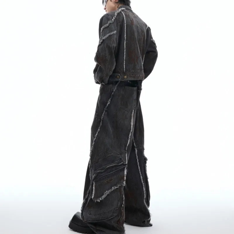 Black gradient distressed denim coat with padded shoulders and matching trousers, featuring raw edges and splash-dye finish.