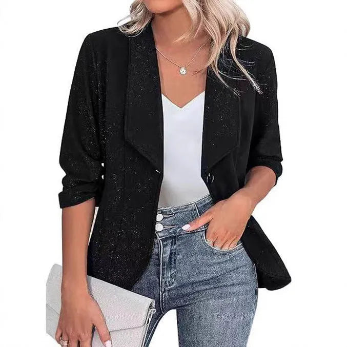 Slim-fitting black polyester suit jacket with long sleeves on a hanger.