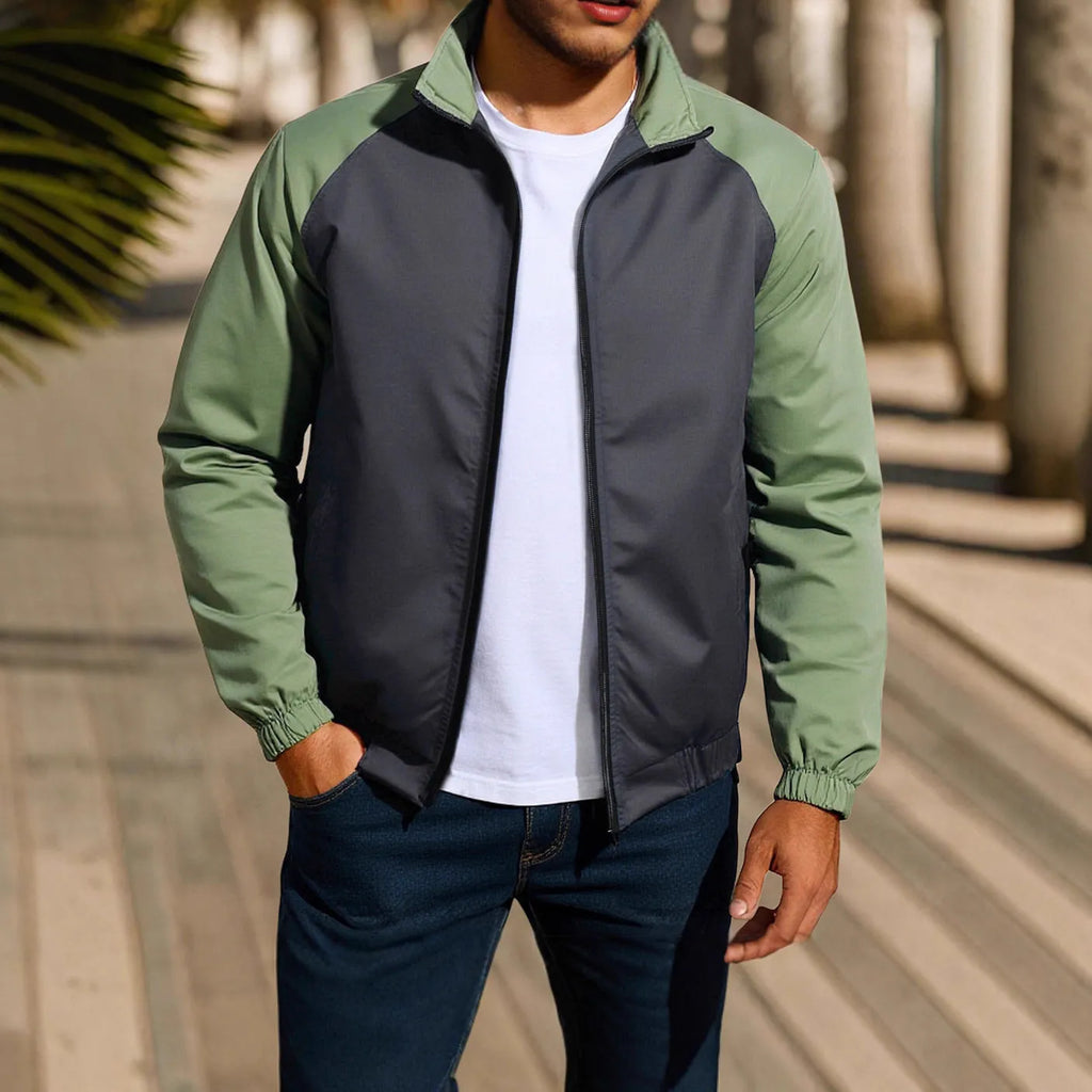 Man wearing a green stand collar casual jacket with raglan sleeves.