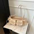 Women's pleated shoulder bag with a tassel bow, showing multi-pocket design and available in eight colours.