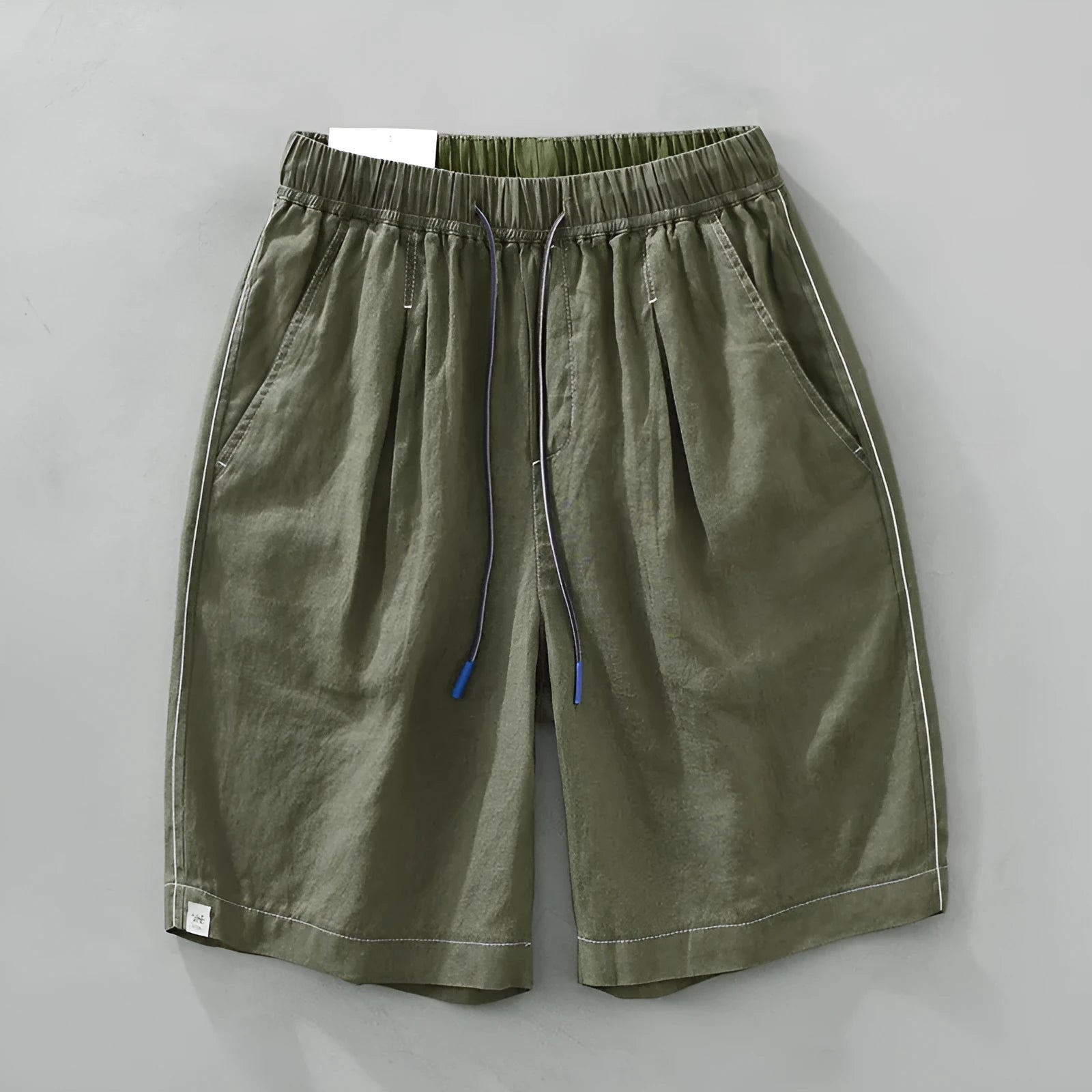 Men's linen shorts in straight drooping style with drawstring waist, shown in green and black colour options