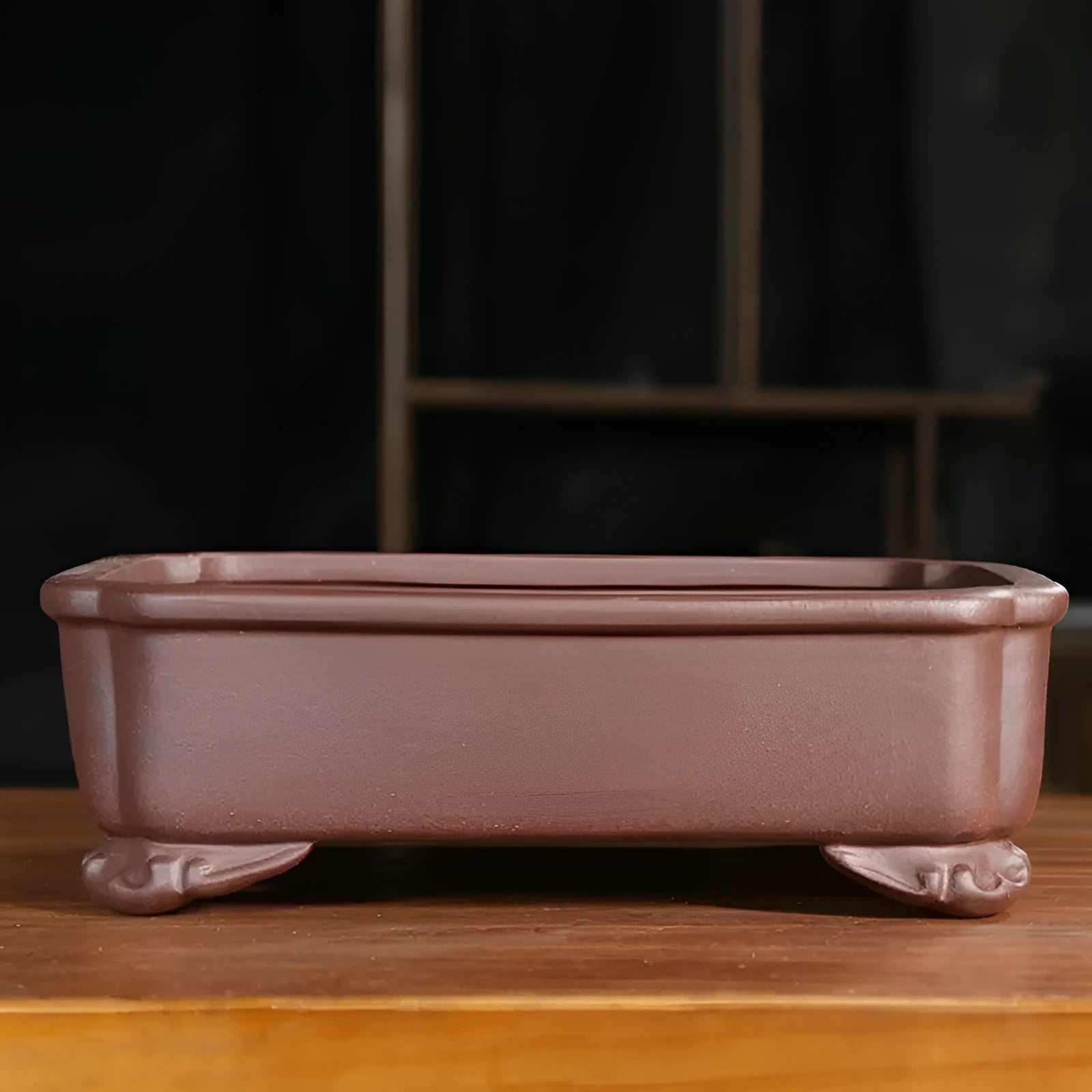 Classical rectangular purple sand bonsai pot with cut corners on a floor.
