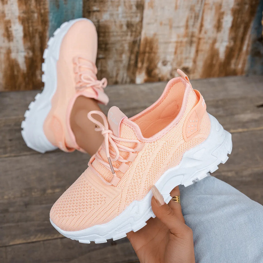 Women's Flyknit mesh casual sports shoes in a flat heel style with a lace-up front.