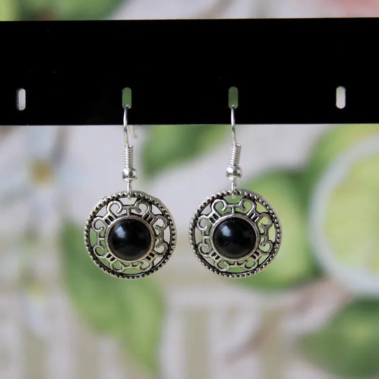 Handmade geometric flower disk earrings made of Tibetan silver and turquoise with ethnic patterns.