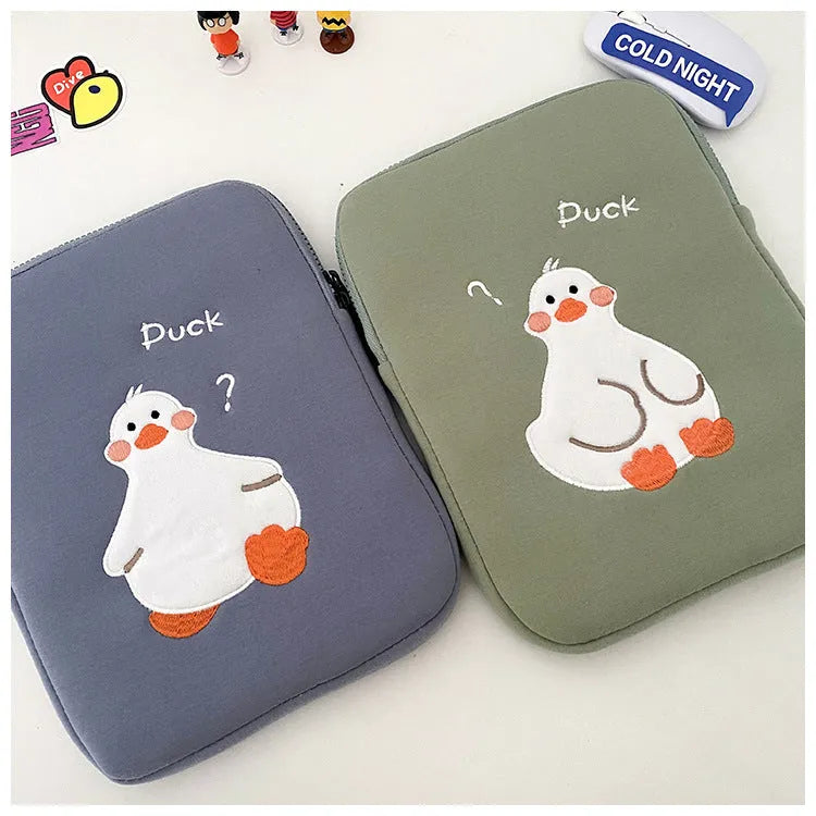 Blue cotton tablet case with embroidered cartoon duck design and zipper closure.
