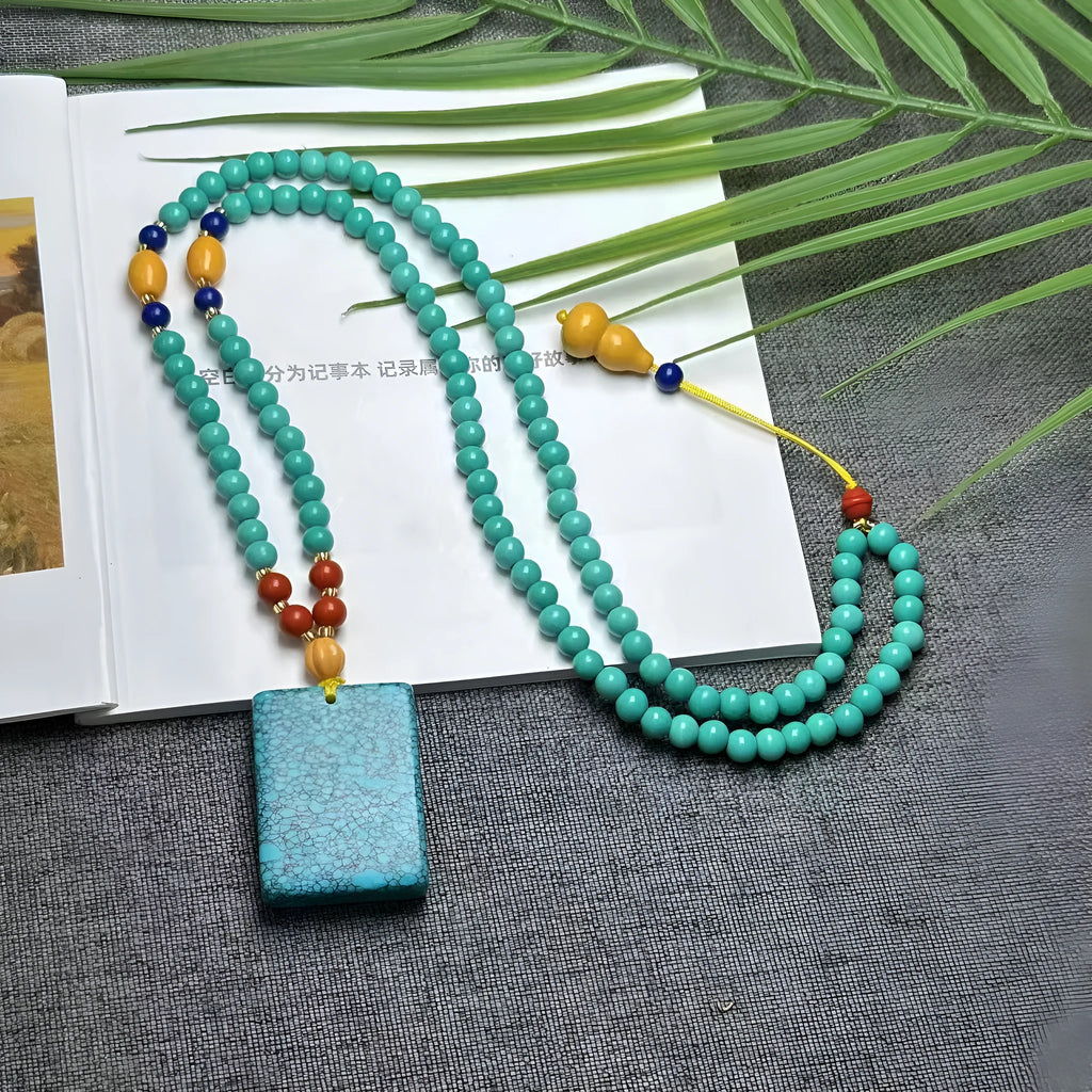 Turquoise clavicle necklace with hand-woven mesh flower pendant on ball bead chain, adjustable length