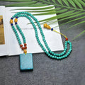 Turquoise clavicle necklace with hand-woven mesh flower pendant on ball bead chain, adjustable length