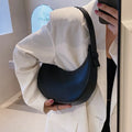Retro dumpling-shaped black PU leather women's shoulder bag with a front sandwich pocket.