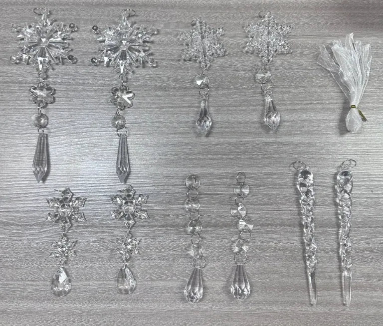 Set of ten clear acrylic icicle and snowflake Christmas ornaments with white hanging ribbons.